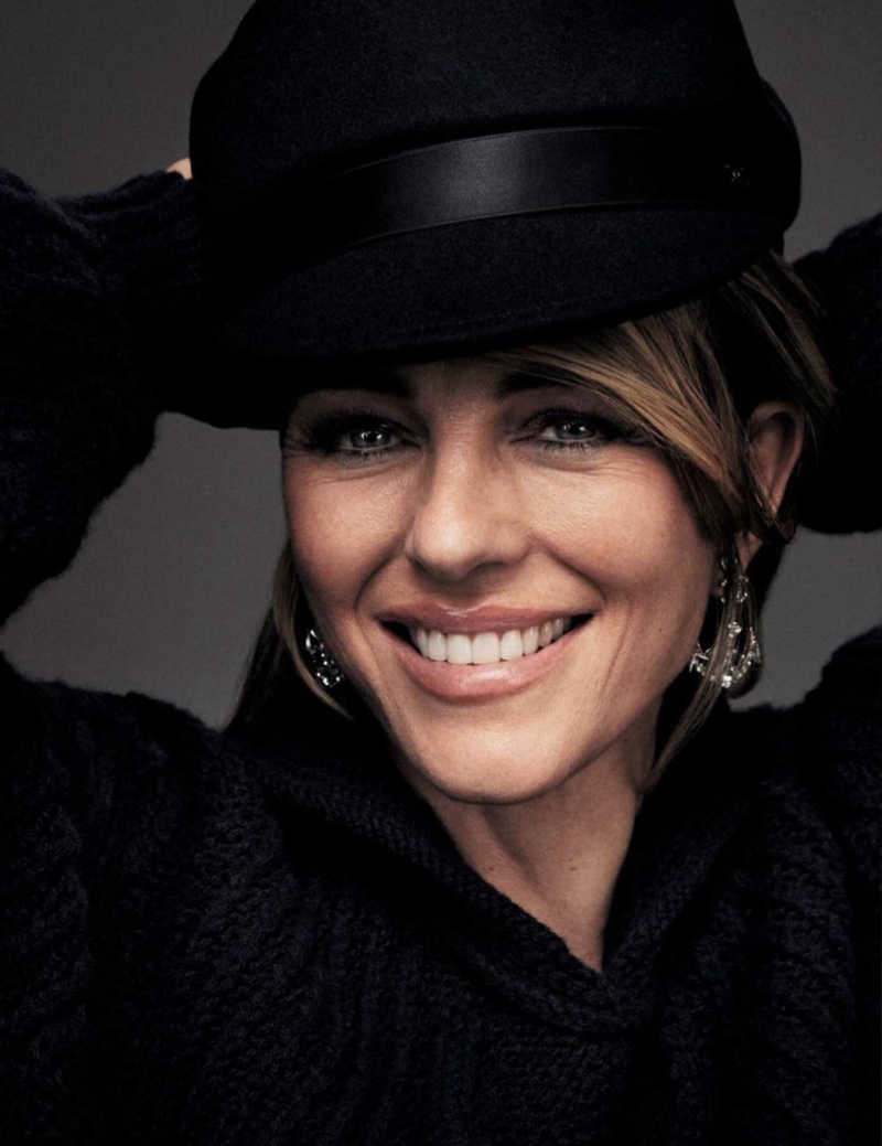 Flashing a smile, Elizabeth Hurley dresses in black