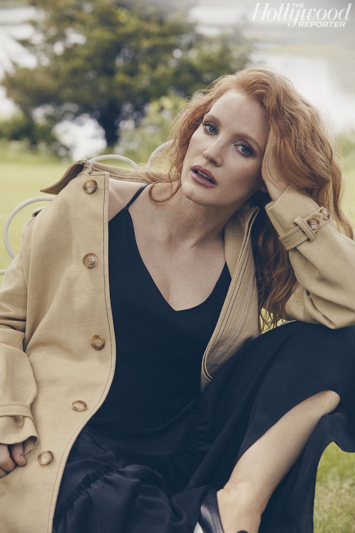 Actress Jessica Chastain poses in black dress and camel coat