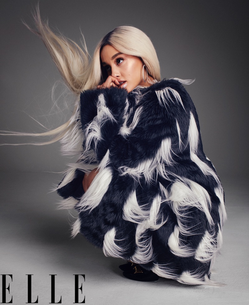 Singer Ariana Grande poses in Givenchy faux fur coat, Hearts On Fire earrings and Louis Vuitton pumps