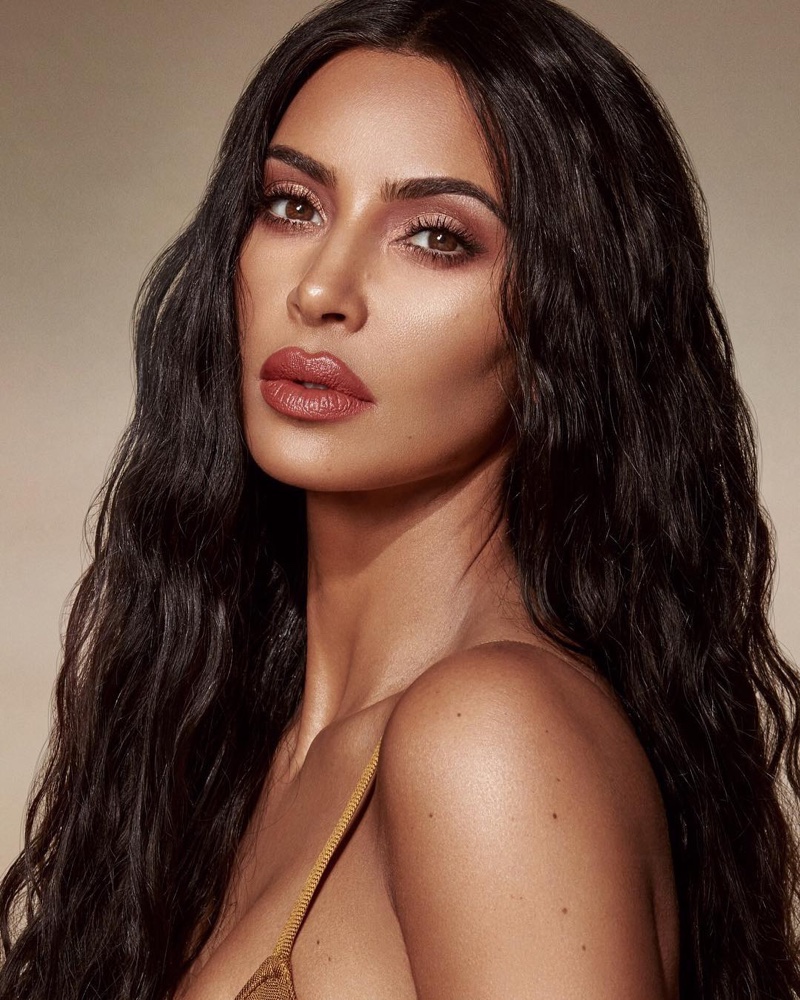 Wearing KKW Beauty Crème Lipstick in Peach 4, Kim Kardashian models the Classic Collection