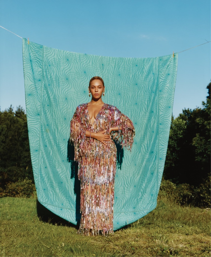 Posing outdoors, Beyonce wears Gucci dress and Bulgari earrings