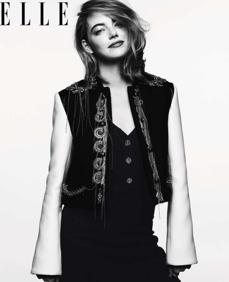 Photographed in black and white, Emma Stone poses in Louis Vuitton jacket and dress