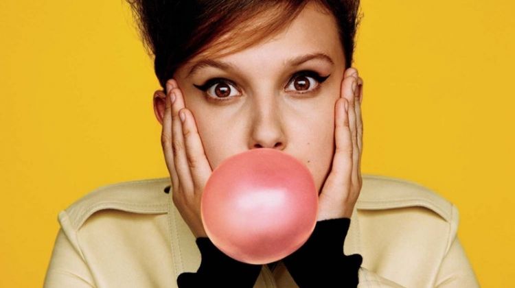 Posing with bubblegum, Millie Bobby Brown wears Calvin Klein dress and turtleneck