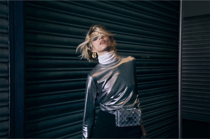 Anja Rubik poses in Zara metallic top, white turtleneck and knitted trousers with vinyl belt bag