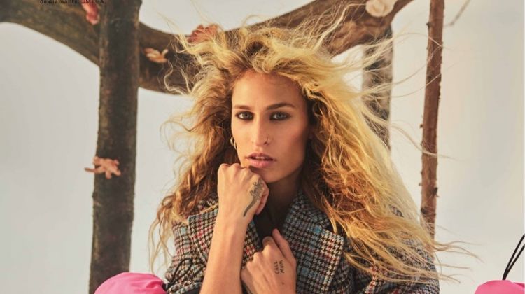 Alice Dellal wears Prada coat, boots and pants with OMEGA watch