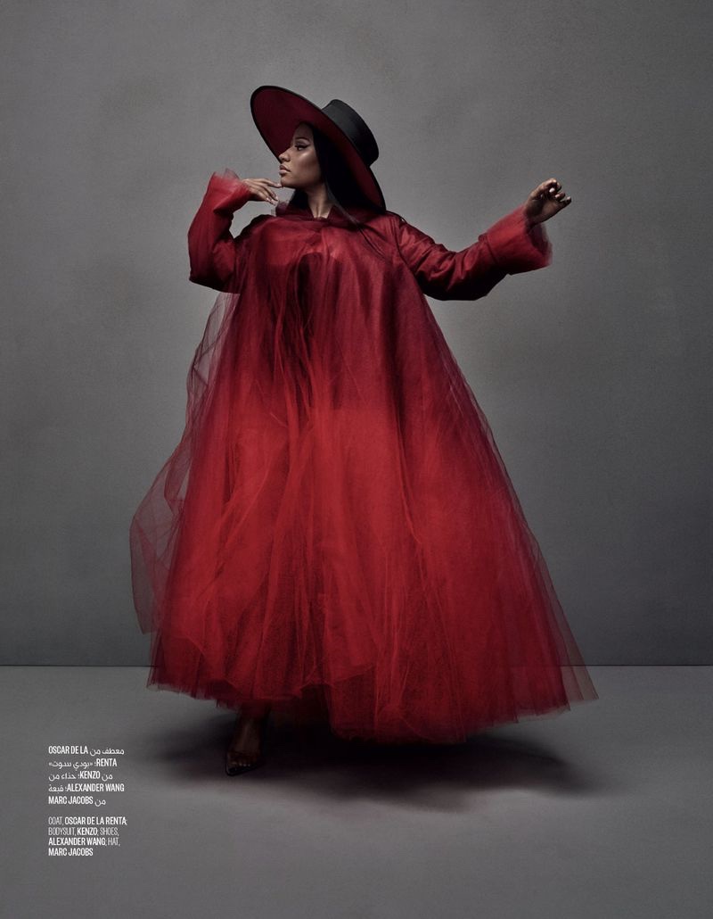 Striking a pose, Nicki Minaj wears Oscar de la Renta coat, Kenzo bodysuit, Alexander Wang shoes and Marc Jacobs hat