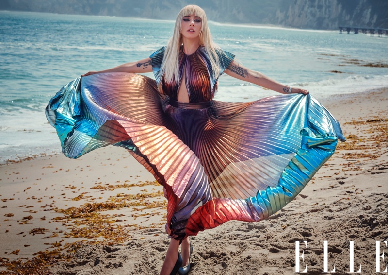 Posing on the beach, Lady Gaga wears pleated and multicolored dress