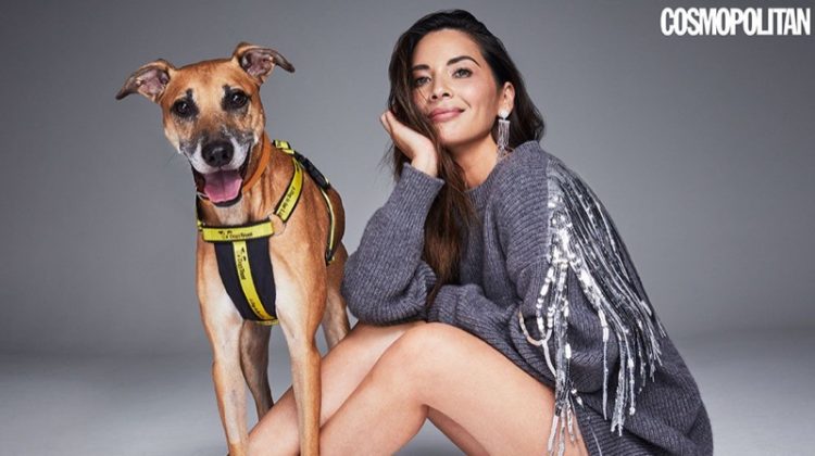 Posing with a dog, Olivia Munn wears fringed sweater