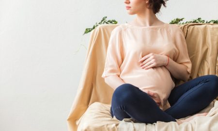 3 Causes for a False Pregnancy Test Pregnant Woman in Pink Top