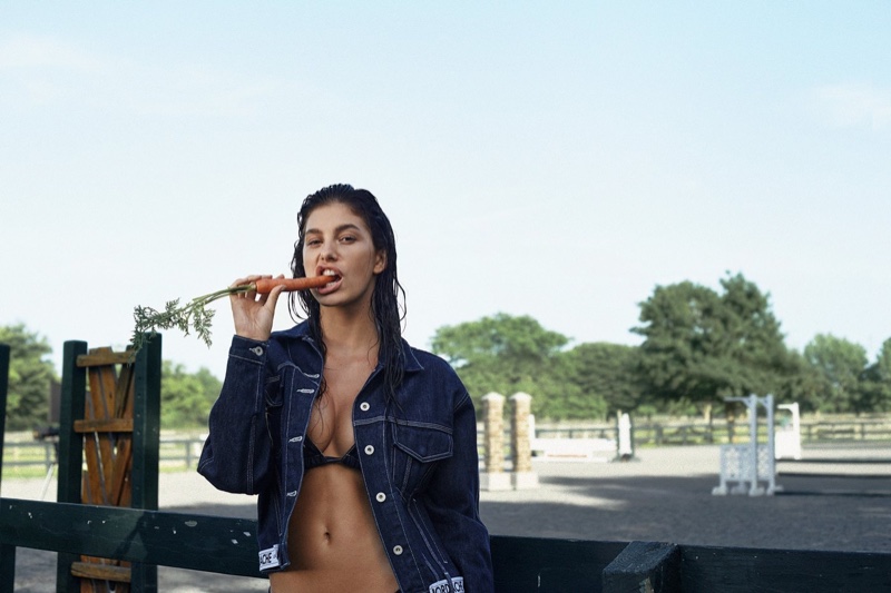 Eating a carrot, Camila Morrone appears in Jordache resort 2019 campaign