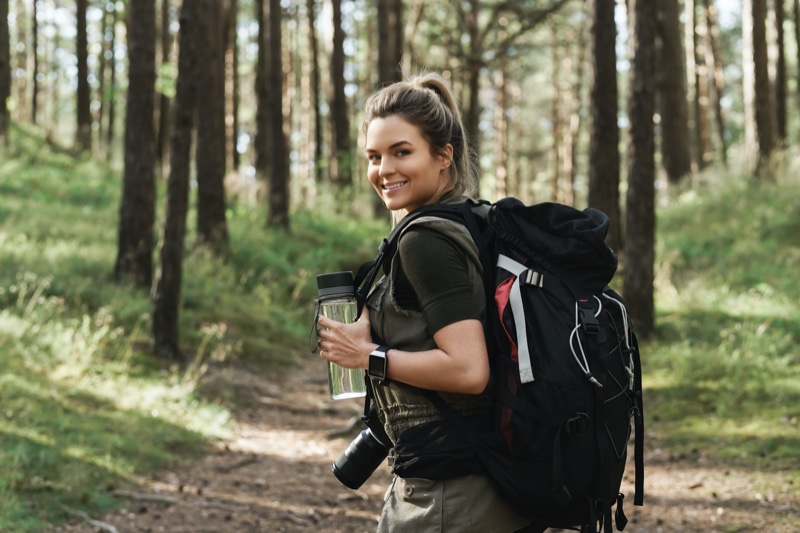 happy woman trails hiking backpack water