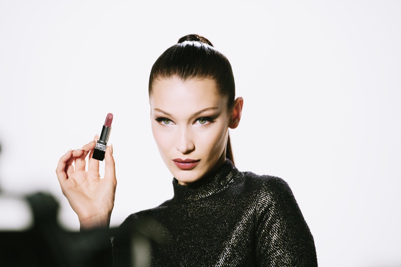 Wearing a sleek ponytail, Bella Hadid poses on set of Rouge Dior Wishes campaign