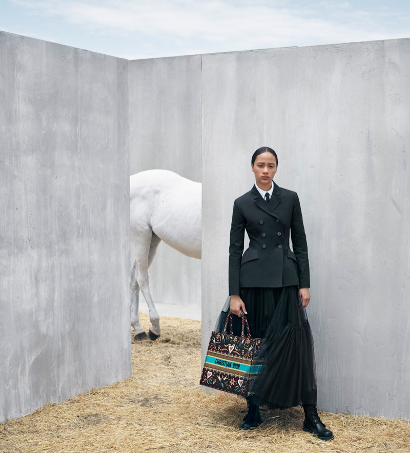 Selena Forrest poses with the Dior Book Tote bag from the brand's cruise 2019 collection