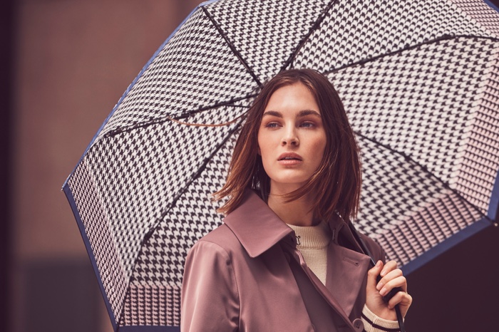 Posing with an umbrella, Laura Love appears in London Fog fall-winter 2018 campaign