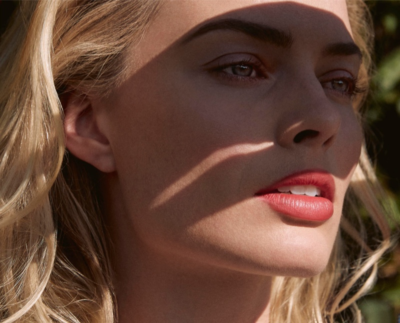 Facing the sun, Margot Robbie shows off a coral pout