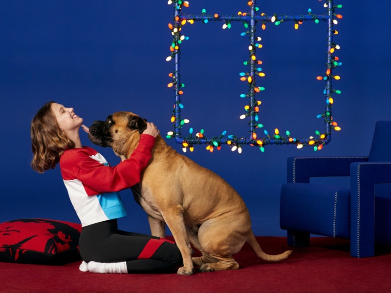 Millie Bobby Brown poses with a dog and festive lights for Calvin Klein