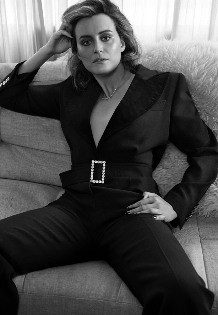 Photographed in black and white, Taylor Schilling wears Tom Ford jumpsuit