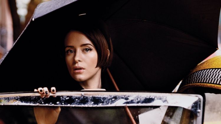 Posing next to a cab, Claire Foy wears Prada coat and Prada headband