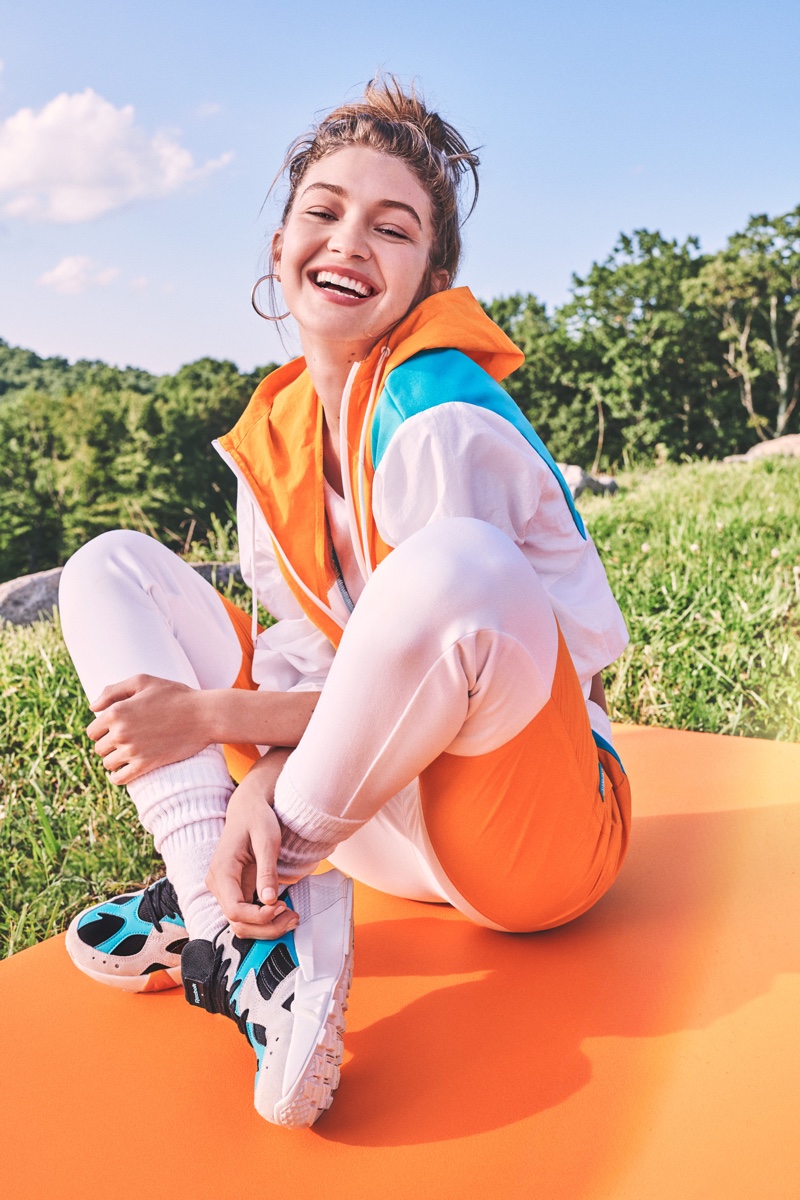 Flashing a smile, the supermodel wears Gigi x Reebok look