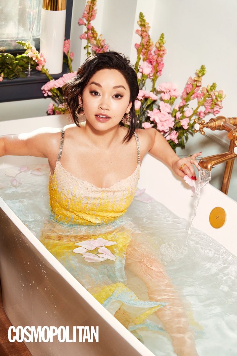 Posing in a bathtub, Lana Condor wears a yellow dress