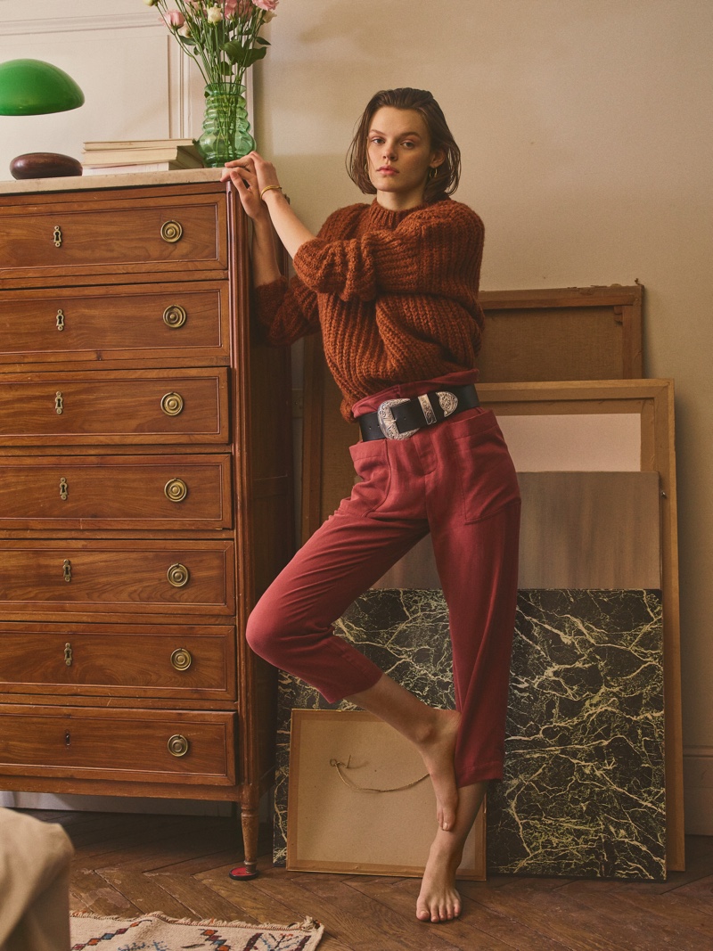 Cara Taylor models knit sweater with high-waisted pants from Mango