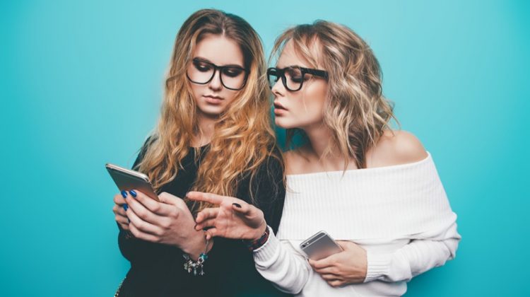 Women Looking at Phones with Glasses