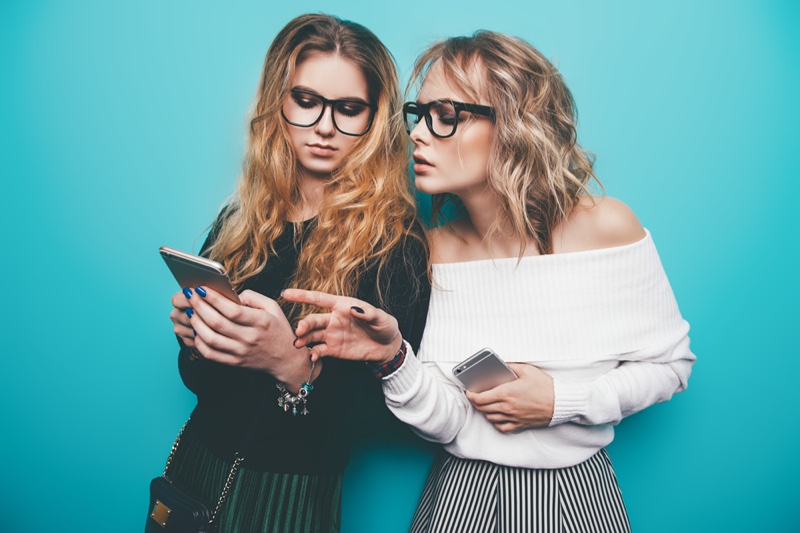 Women Looking at Phones with Glasses