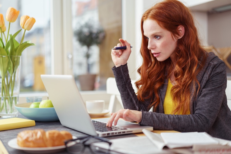 Woman Typing Laptop Red Hair Wearing Hoodie