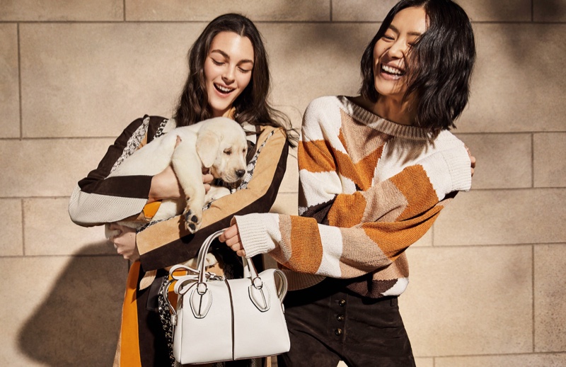 BACKSTAGE: Liu Wen and Vittoria Ceretti pose with a dog on set of Tod's spring 2019 shoot