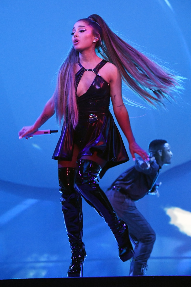 Ariana Grande poses in Versace minidress in black jersey with Swarovski crystals and thigh-high boots. Photo: Kevin Mazur/Getty Images for Ariana Grande