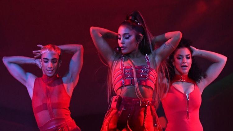 Dressed in red, Ariana Grande wears bondage inspired look from Versace on Sweetener World Tour. Photo: Kevin Mazur/Getty Images for Ariana Grande