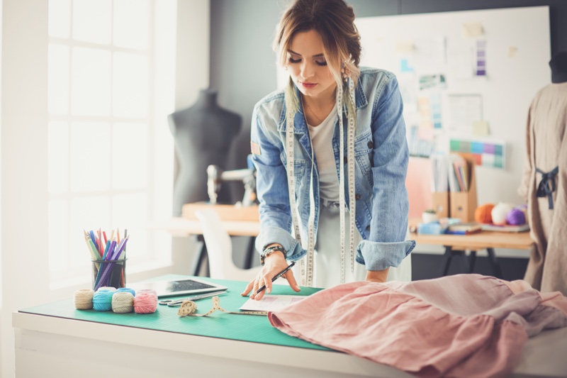 Female Fashion Designer with Measuring Tape Wearing Denim Jacket