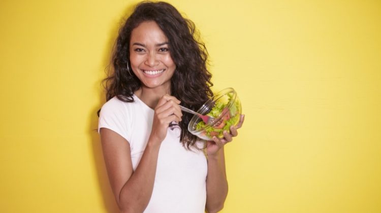 Tips On Eating Healthier All the Time Model Smiling with Salad Wavy Hair White Tee