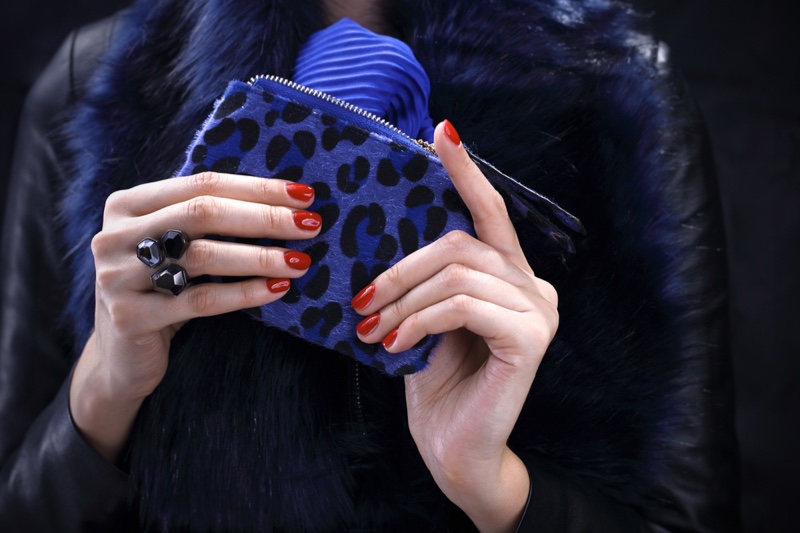 Woman with Blue Leopard Print Wallet and Red Nails