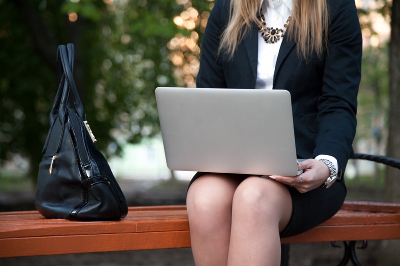 Woman in Business Outfit with Laptop and Bag