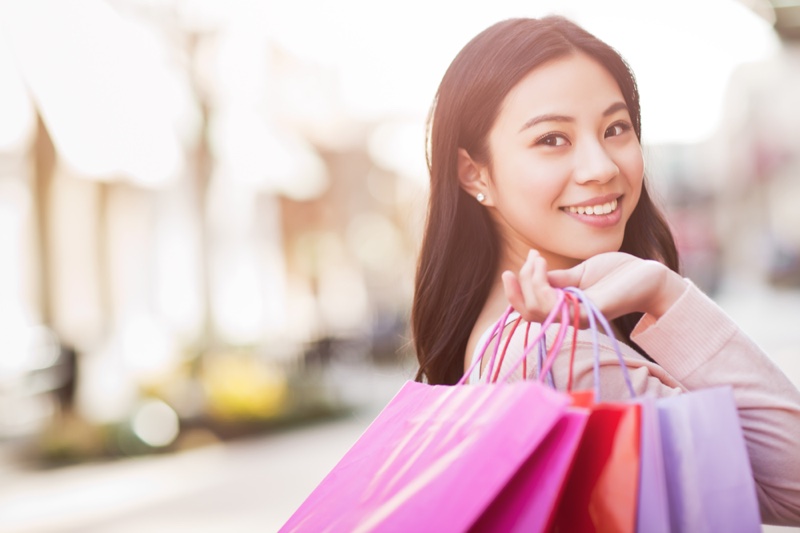 Asian Woman Smiling with Shopping Bags