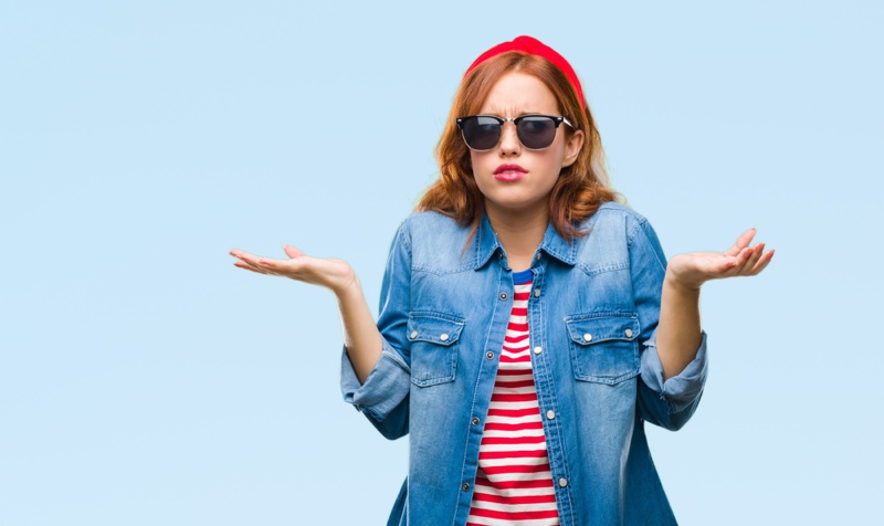 Woman Shrugging Shoulders in Denim and Stripes