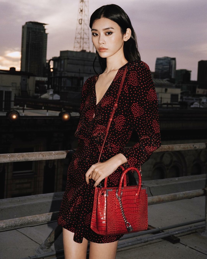 Ming Xi shows off The Kooples bag collaboration in a red version
