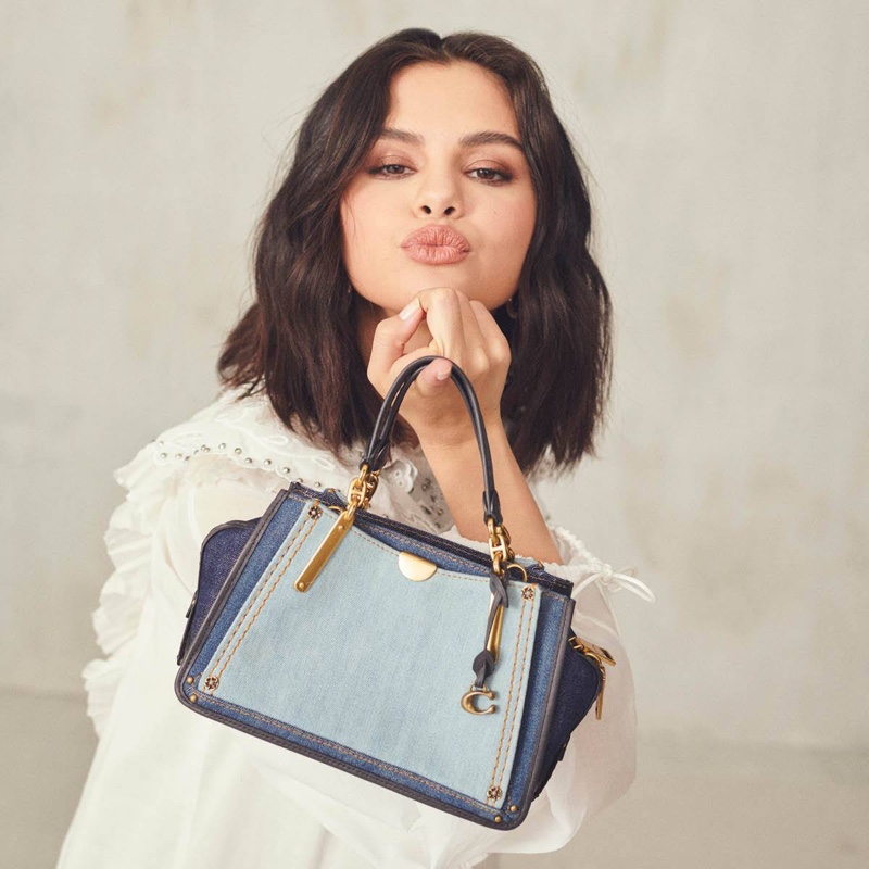 Posing with the Dreamer 21 bag in denim, Selena Gomez rocks Coach designs