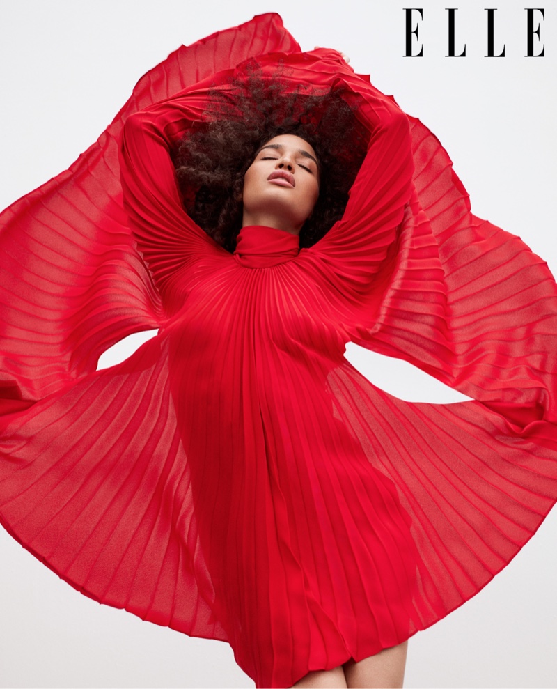 Striking a pose, Indya Moore wears a red Valentino dress