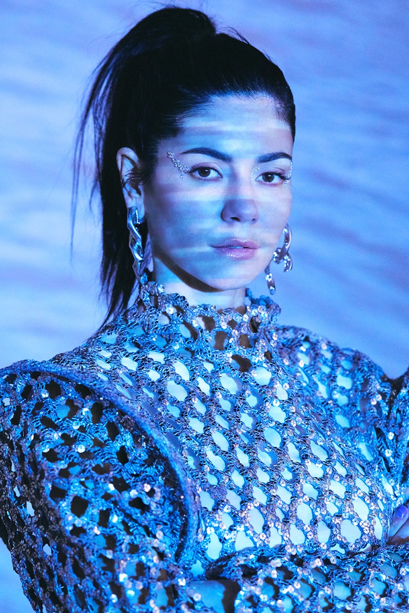 Marina Diamandis poses in Louis Vuitton dress with Annelise Michelson earrings