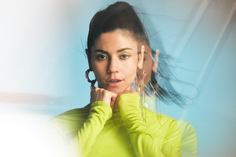 Sporting neon green, Marina Diamandis poses in Versace dress with Givenchy earrings