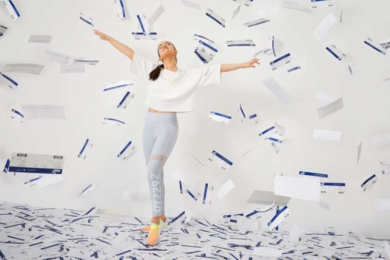Posing with airline tickets, Selena Gomez strikes a pose