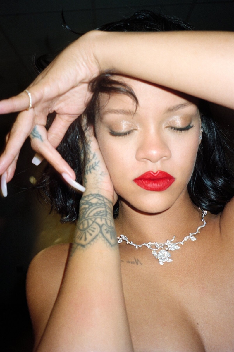 Showing off a red lip color, Rihanna poses in Dior Fine Jewelry