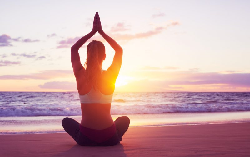 Woman Doing Yoga at Beach