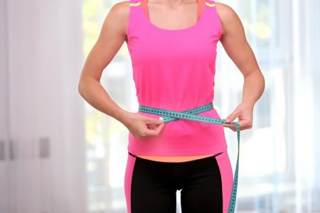 Woman Measuring Waist Pink Top Workout Clothes