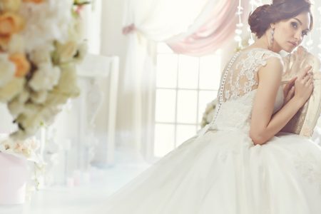 5 Things to Keep in Mind When Shopping for a Wedding Dress Brunette Model Bridal Wedding Dress Chair Back