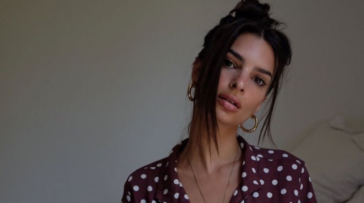 Modeling in bed, Emily Ratajkowski tries on Inamorata shirt in polka dot