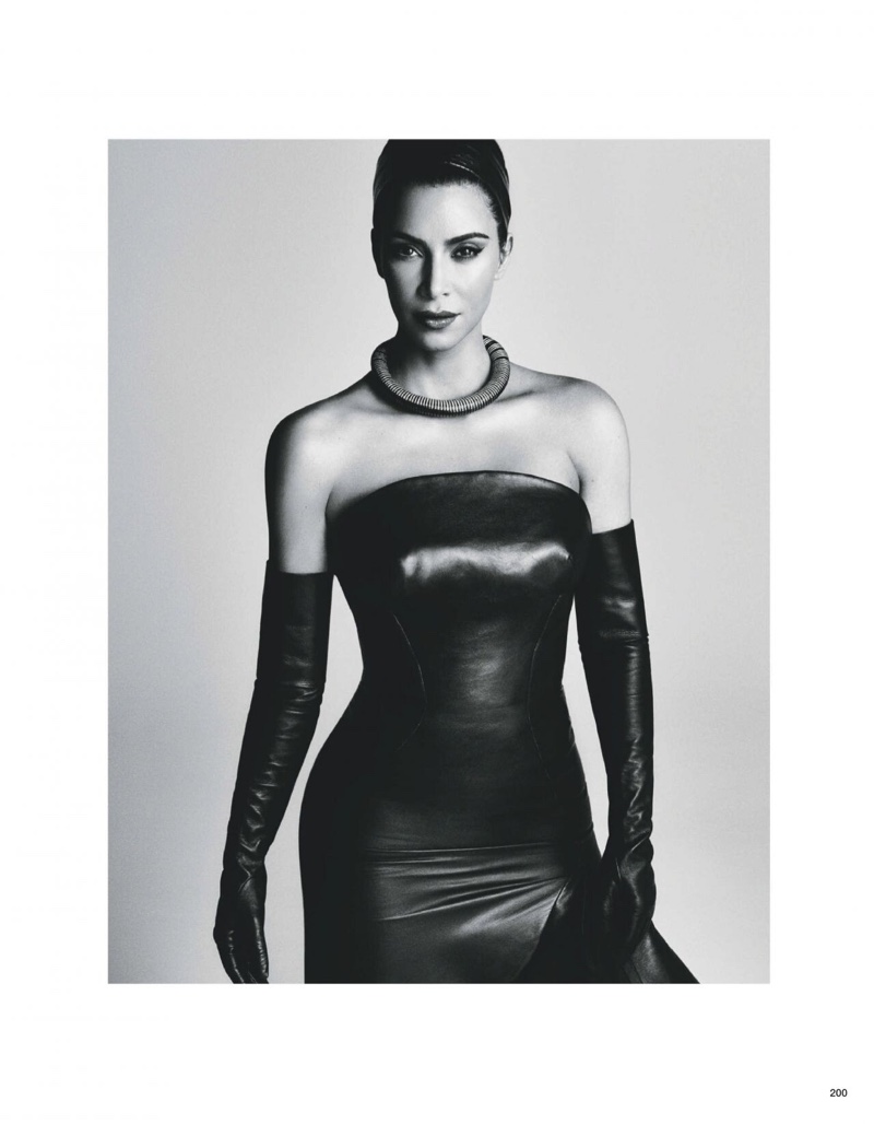 Caption Wearing a form-fitting look, Kim Kardashian poses in black and white