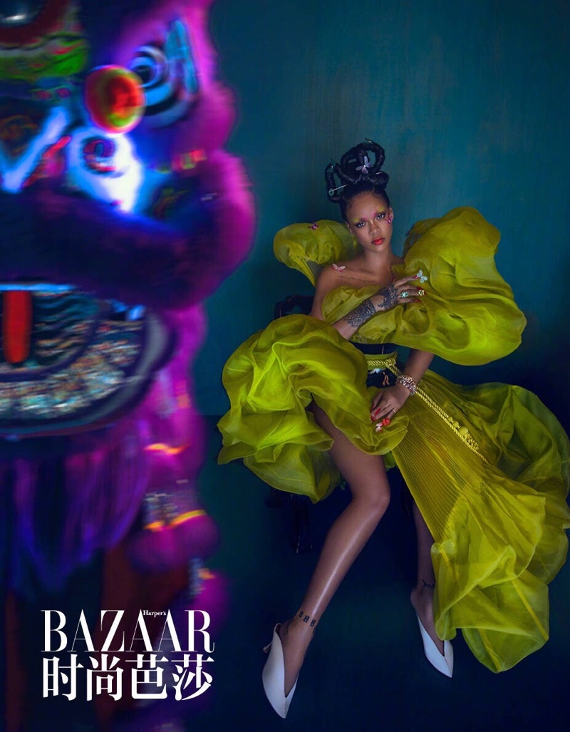 Posing in green, Rihanna shows off her long legs
